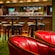 An Irish Pub called O Gills has lots of bar tables with stools and chairs with cocktail tables